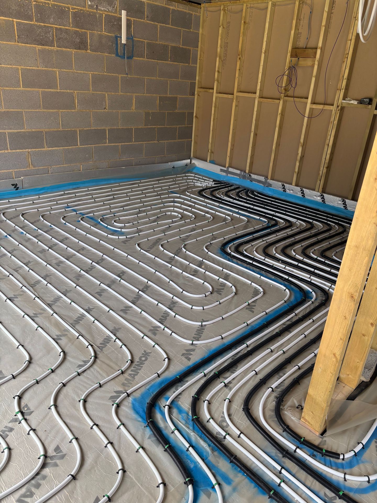 In-screed underfloor heating loops routed back towards the manifold