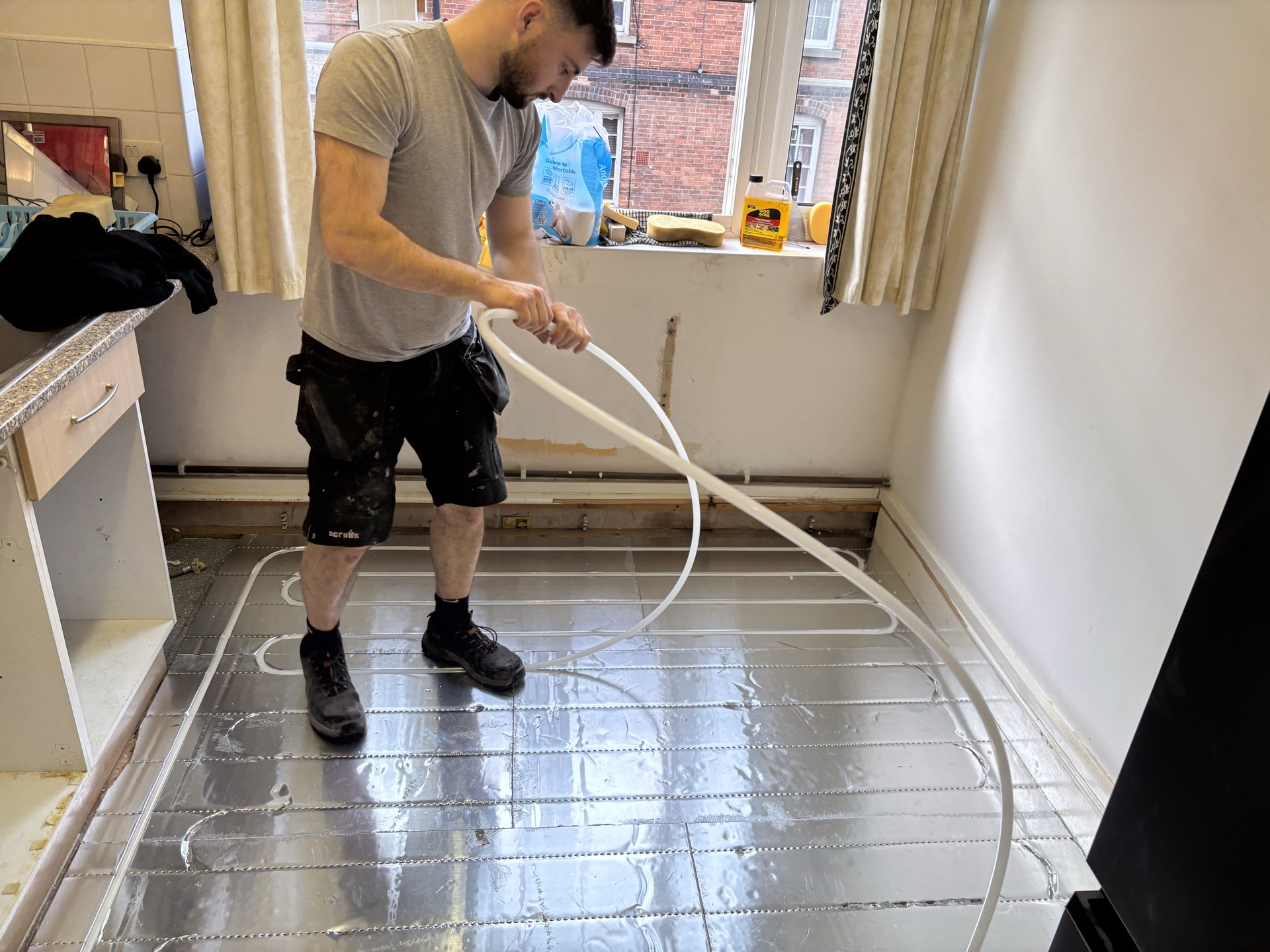 Jake routing PE-RT pipe in a kitchen retrofit install