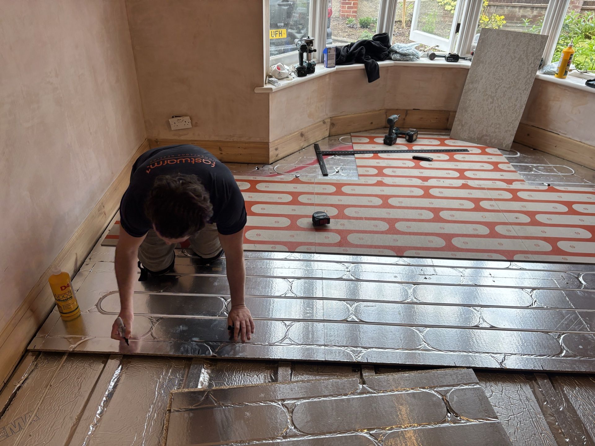 Laying pipe into the pre-routed chipboard grooves