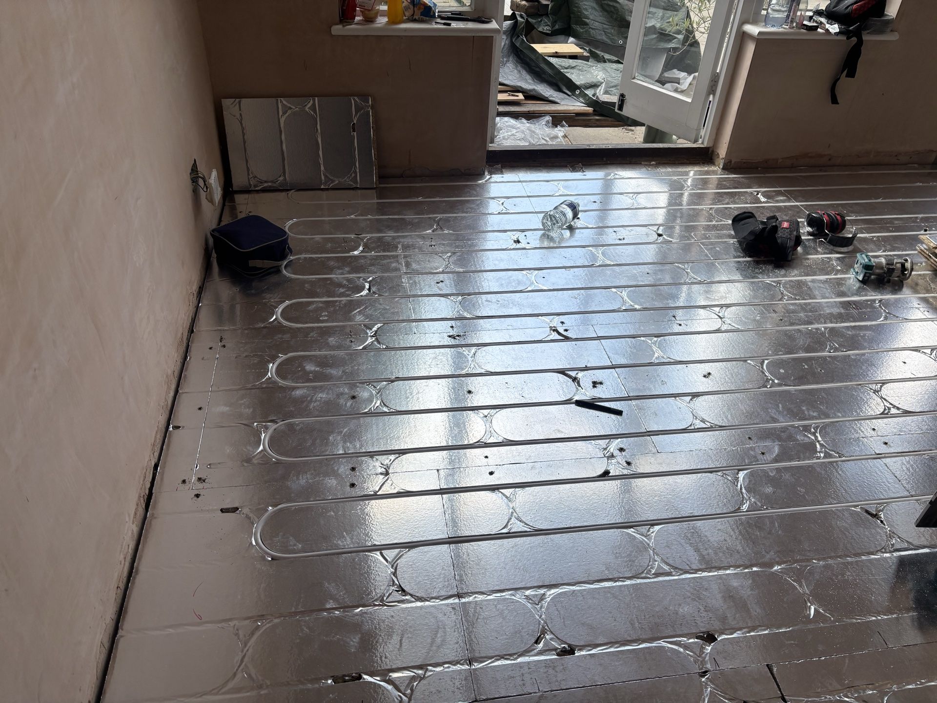 Structural chipboard underfloor heating across a room