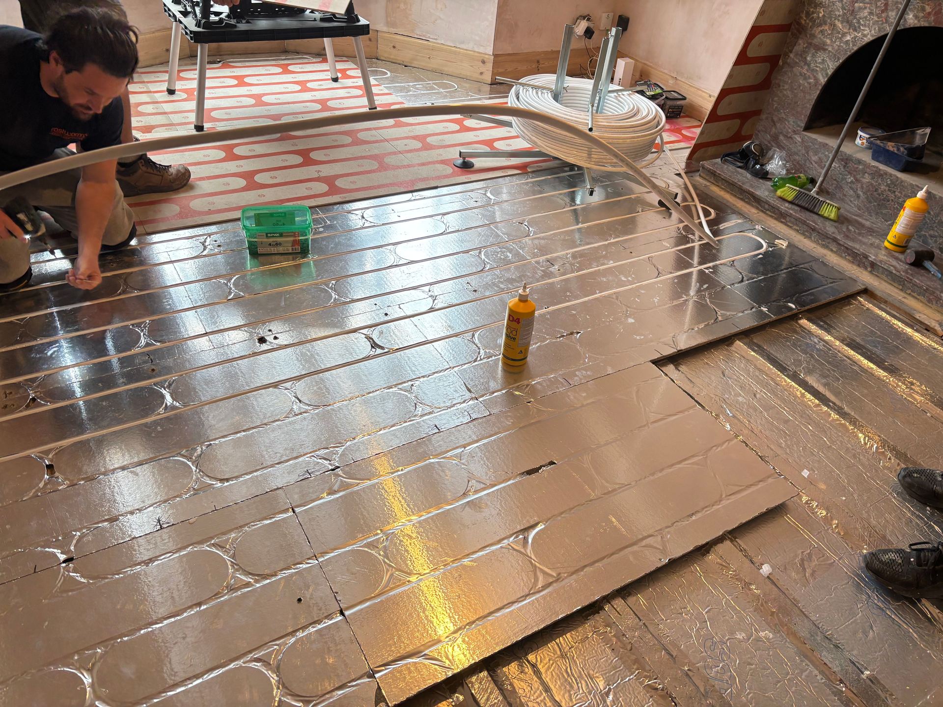 Laying structural chipboard heating panels in a Kent living room