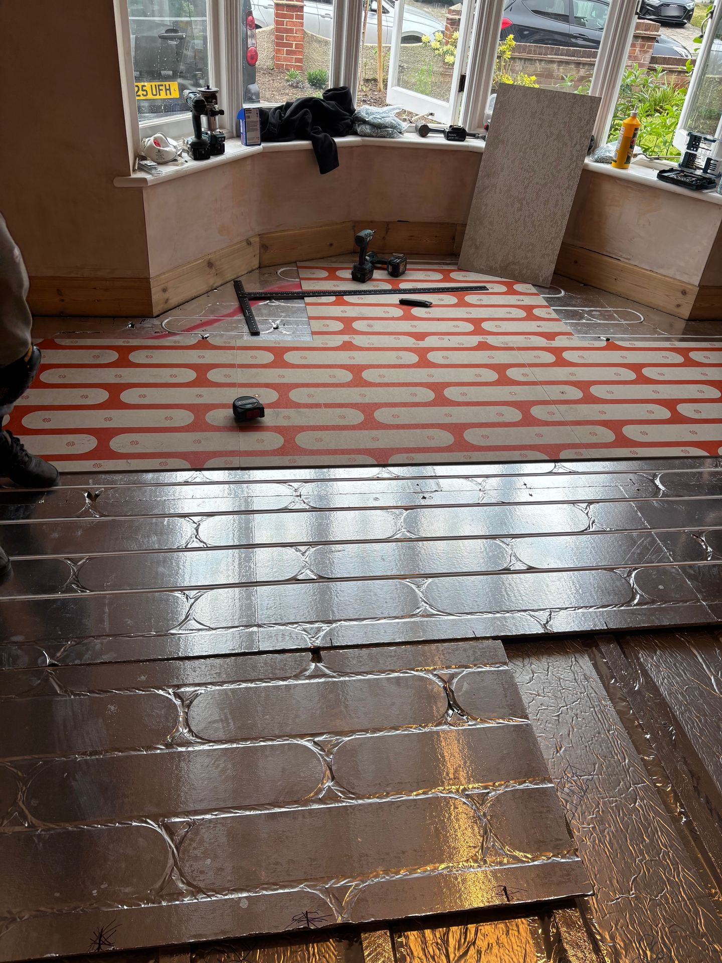 Structural chipboard heating deck going down in a bay window room