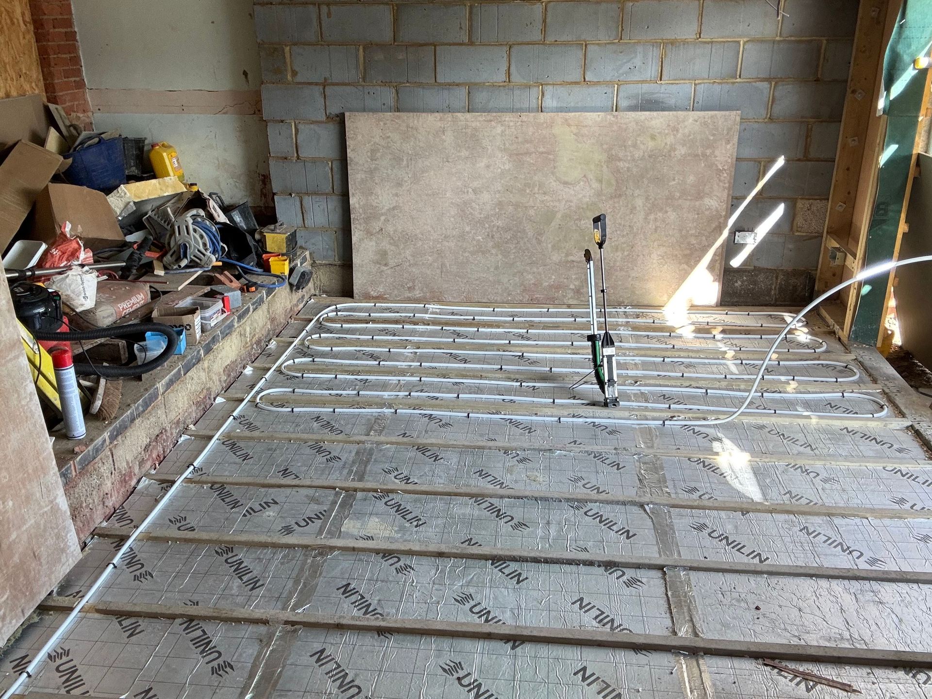 Between joist heating pipe worked across a suspended timber floor