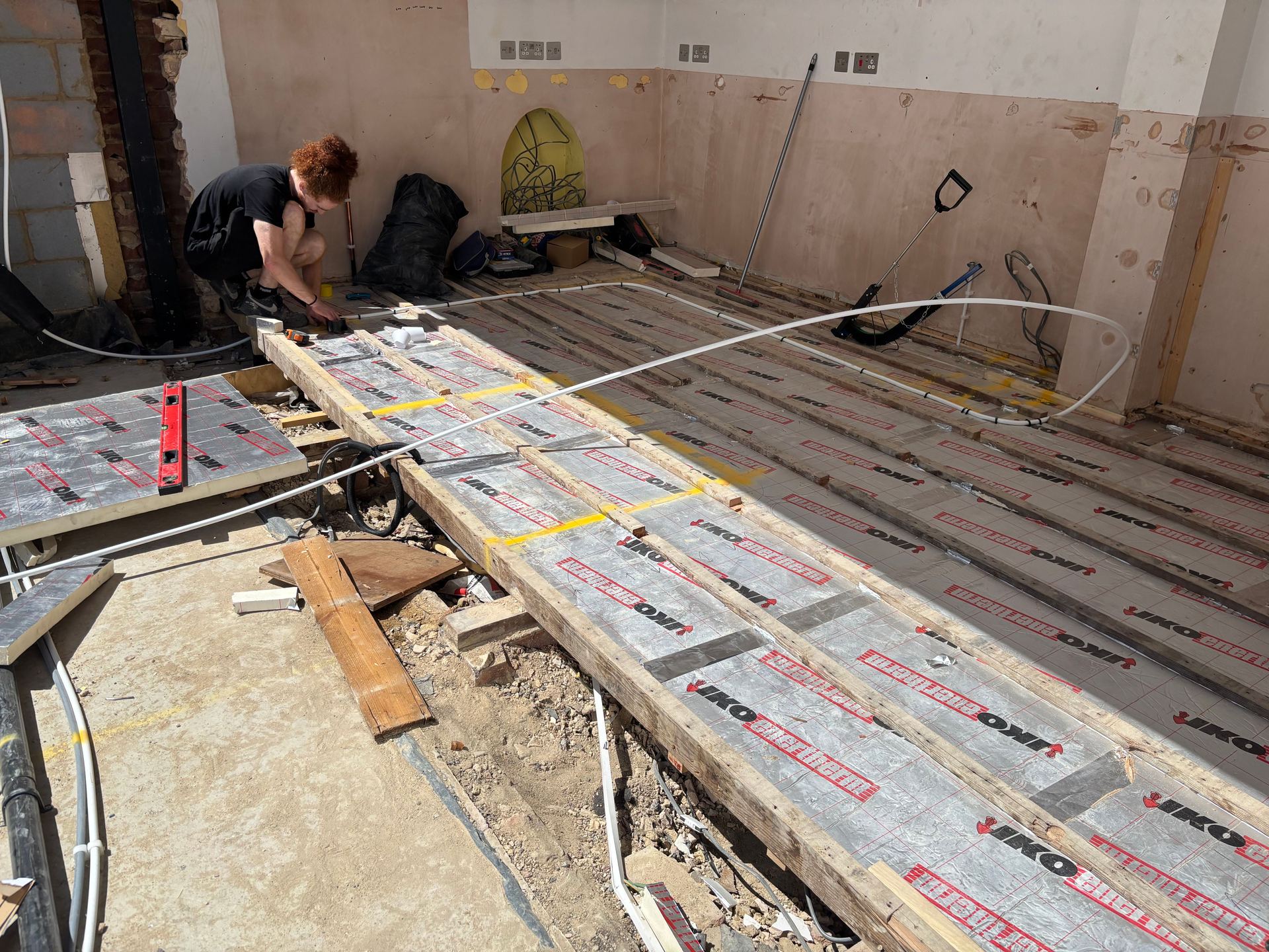 Insulation boards fitted between joists before the pipe goes in