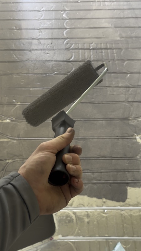 Smoothing roller working over silver retrofit overlay boards