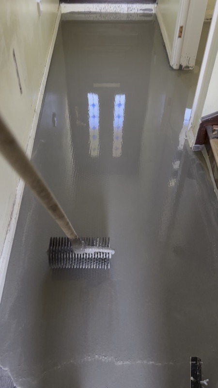 Self-levelling compound spread across a hallway